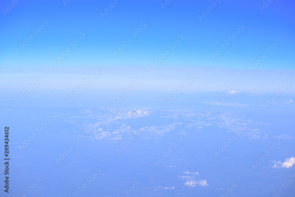 Fototapeta premium Sunrise above clouds from airplane window. From above it is not so terrible. The clouds shines from above with the sun. View from airplane 