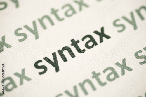 word syntax printed on paper macro photo
