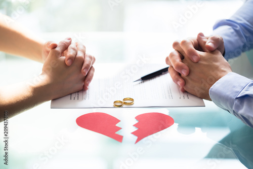 Couple's Hand On Divorce Paper photo