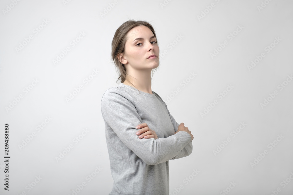 The young woman portrait with proud and arrogant emotions on face. The young woman portrait with proud and arrogant emotions on face.