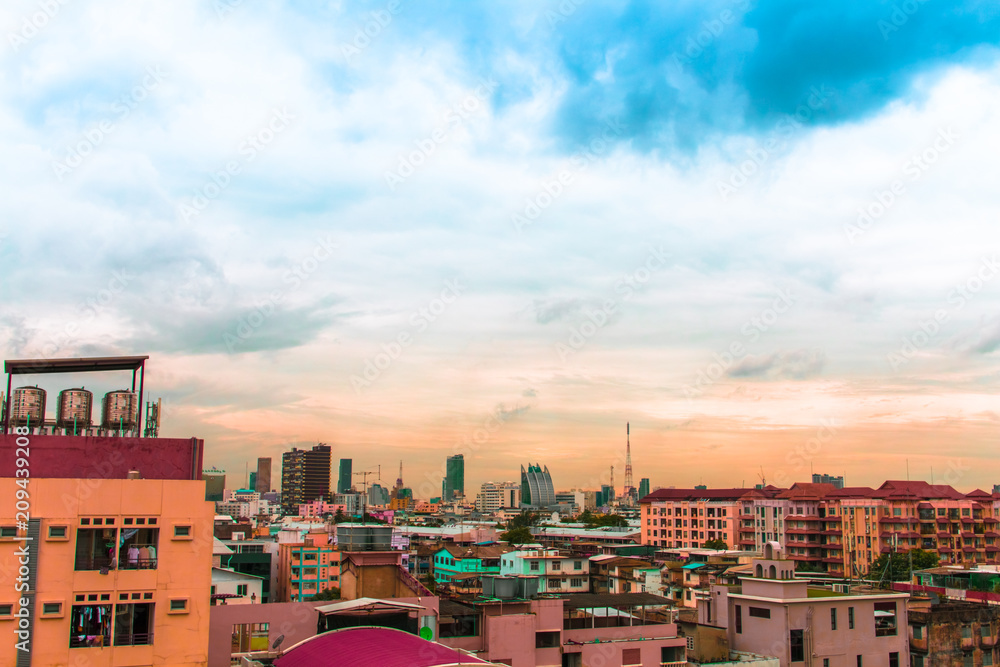 Bird view over cityscape with sun and clouds in the morning.Copy space.Bangkok.Pastel tone.