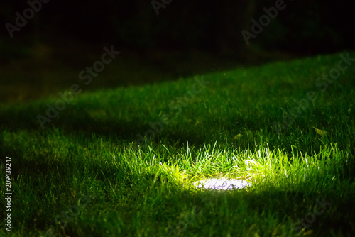 Obraz na płótnie Decorative Garden Light in ground built-in, Lanterns In Flower Bed In Green Foliage. Garden Design w salonie