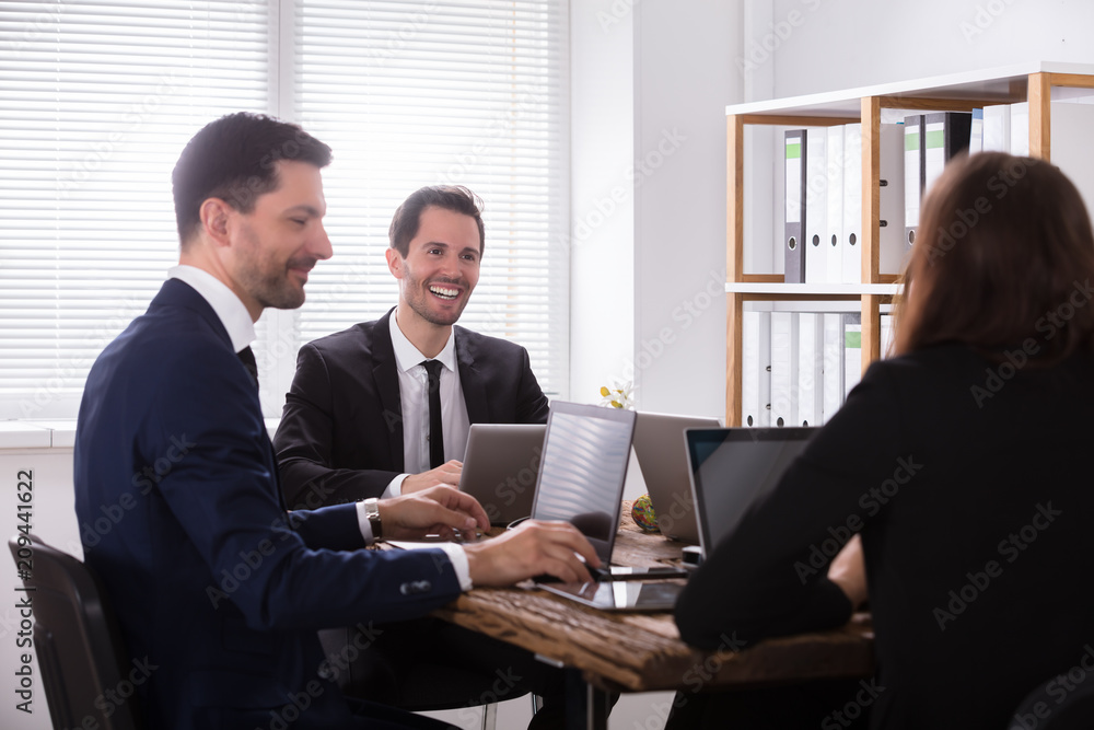 Businesspeople Attending Meeting In Office Businesspeople Attending Meeting In Office