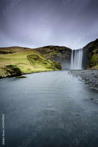 Beautiful Skogafoss. Amazing landscape at sunset in the most popular waterfall in Iceland. Long exposure effect. Dawn in the ring road.