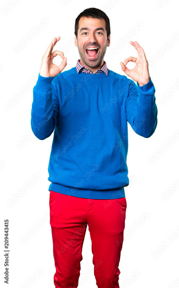 Fototapeta premium Handsome young man making OK sign on white background