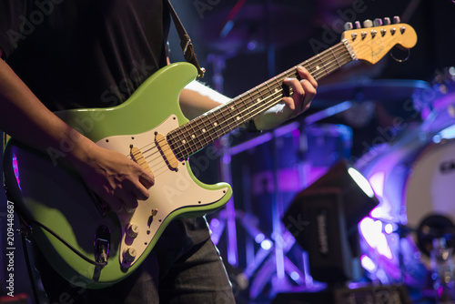 Musician Playing Guitar on stage. 