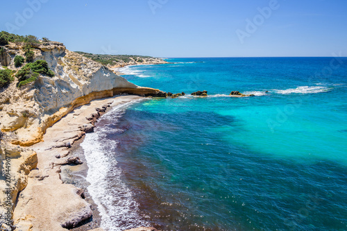 Beach, Greece - Kos Island, Kefalos: Picturesque deep blue Caribbean Bay with wild sea of ​​Greek Agais and steep sandstone cliffs, perfect for wind surfers with heavy waves photo