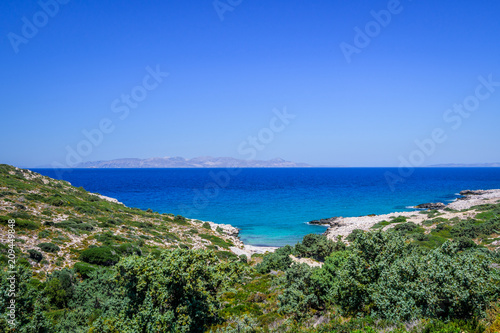 Beach, Greece - Kos Island, Kefalos: Picturesque deep blue Caribbean Bay with wild sea of ​​Greek Agais and steep sandstone cliffs, perfect for wind surfers with heavy waves © Thomas Jastram