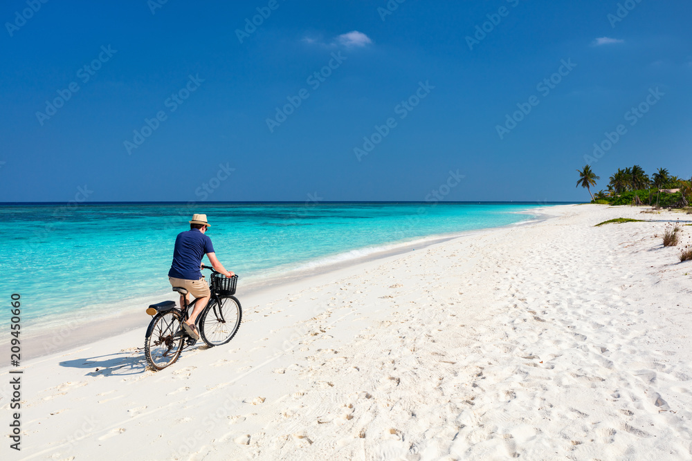 Cycling along tropical beach