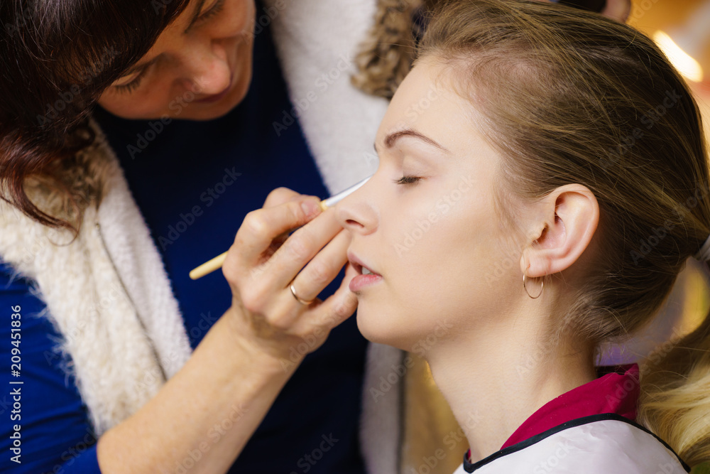 Woman getting eyes make up done by artist Woman getting eyes make up done by artist