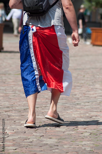 closeup of french supporter of football with french flag on legs in outdoor