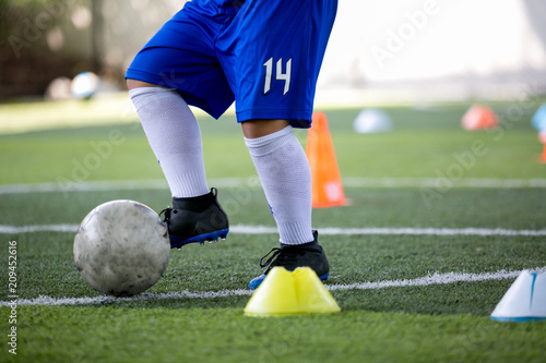 Fototapeta Naklejka Na Ścianę i Meble -  Kid soccer trap and control the soccer ball