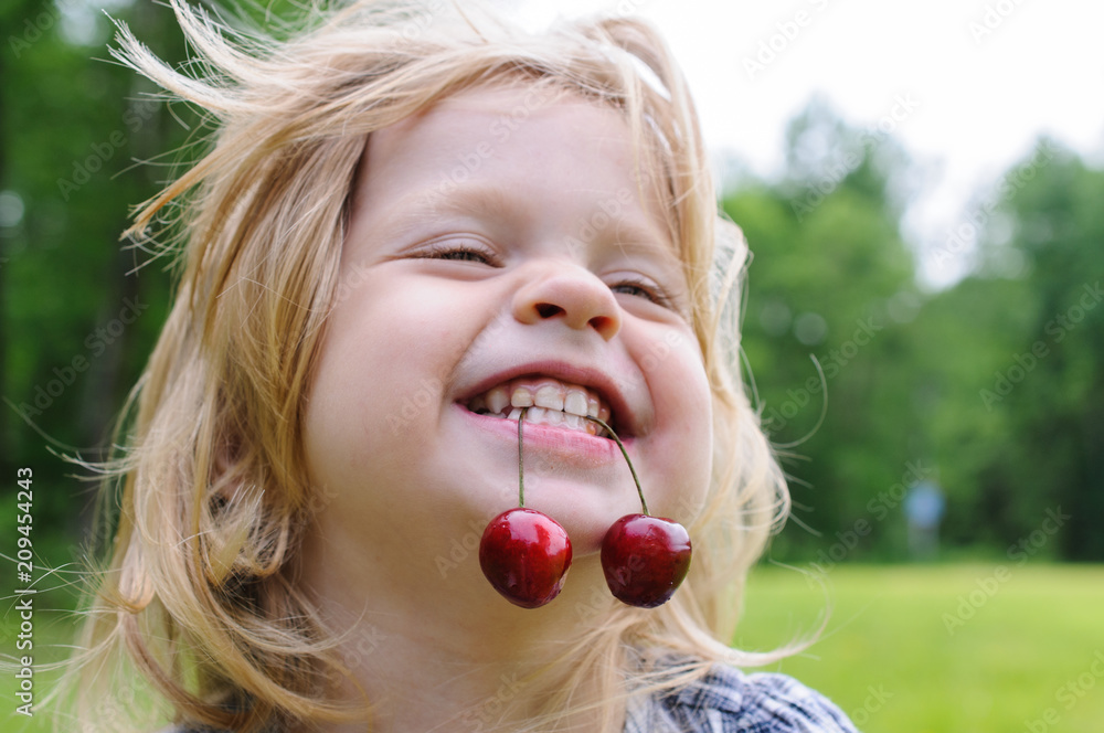 little girl with a sweet cherry in her mouth little girl with a sweet cherry in her mouth