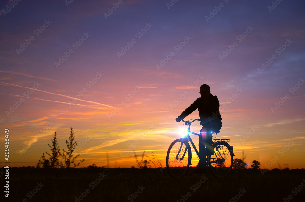 Naklejka premium Man silhouette drive on bicycle