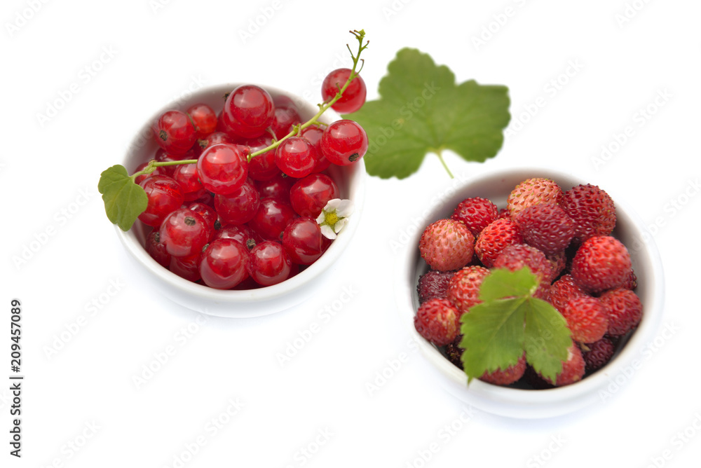 top view on red berries in little bowl on white background top view on red berries in little bowl on white background