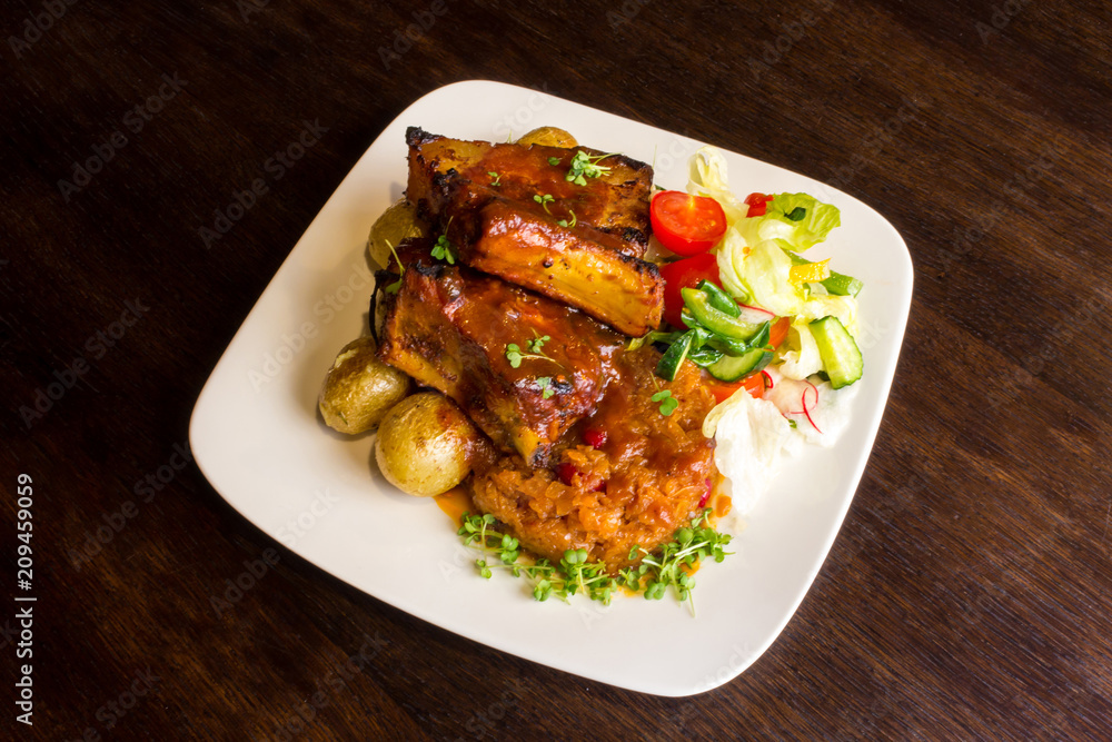 Dish with pork ribs and vegetables Dish with pork ribs and vegetables