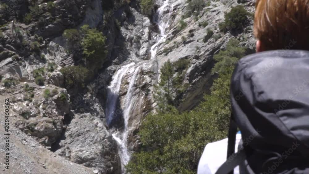 Backpacker looking at a Massive Waterfall on Mt Baldy Backpacker looking at a Massive Waterfall on Mt Baldy