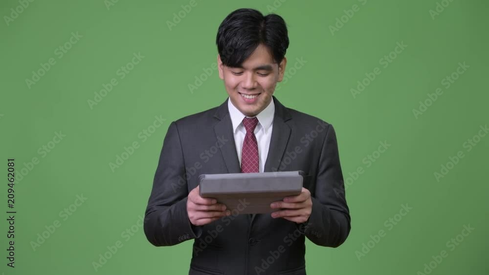 Young handsome Asian businessman using digital tablet Young handsome Asian businessman using digital tablet