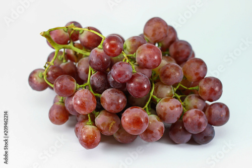 Red grapes on white background.