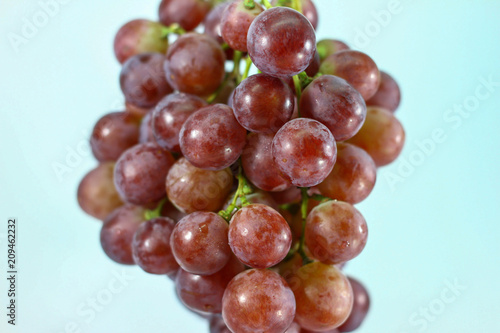 Red grapes on white background.