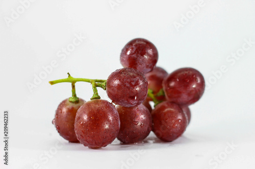 Red grapes on white background.