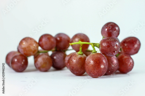 Red grapes on white background.