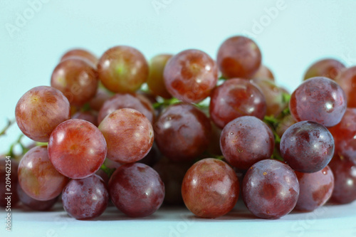 Red grapes on white background.