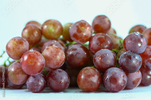 Red grapes on white background.