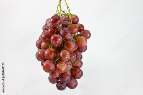 Red grapes on white background.
