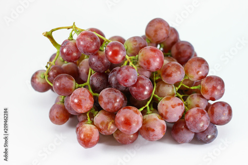 Red grapes on white background.