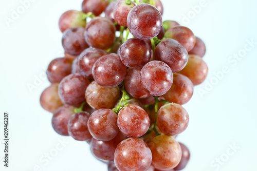 Red grapes on white background.