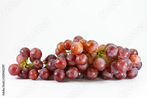 Red grapes on white background.