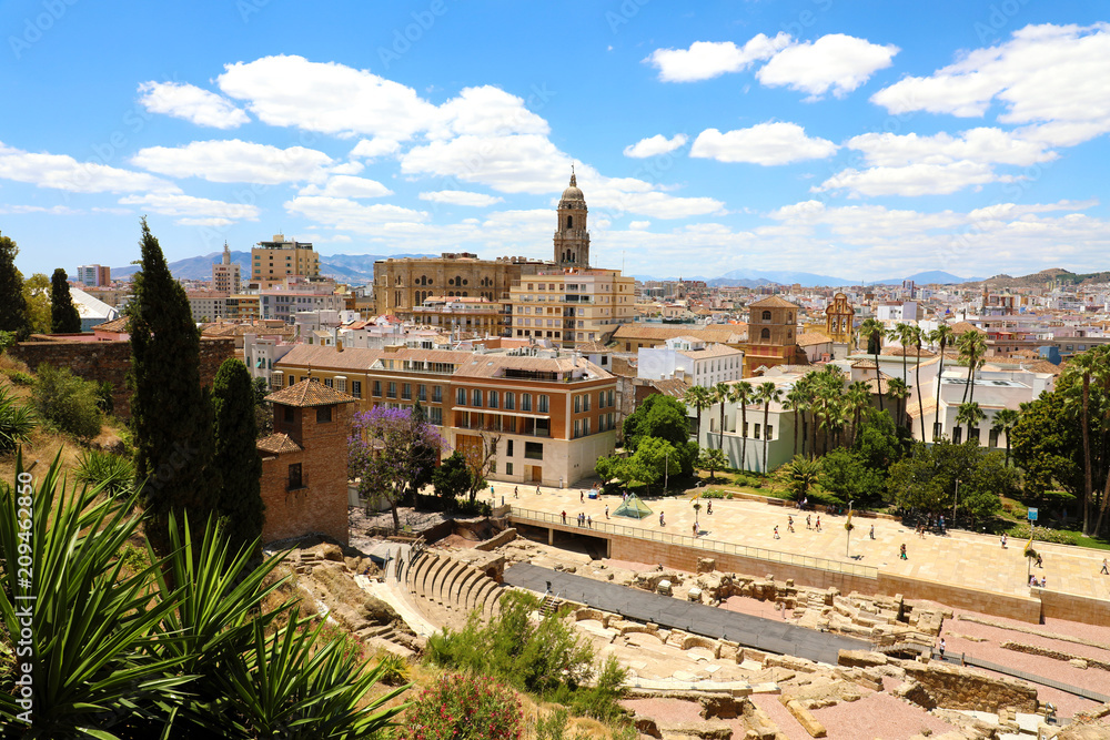 Malaga cityscape with Roman Theater and Cathedral on the background