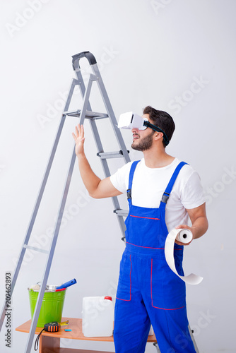 Man with VR glasses gluing wallpaper
