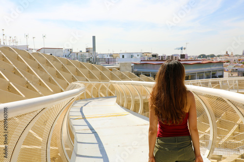 Attractive young woman looking to Seville cityscape, Spain, Europe