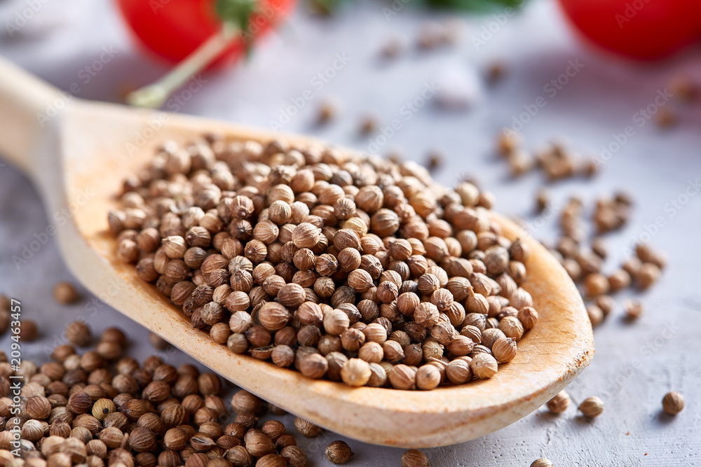 Coriander in wooden spoon with clipping path on white textured background, close-up, selective focus. Coriander in wooden spoon with clipping path on white textured background, close-up, selective focus.