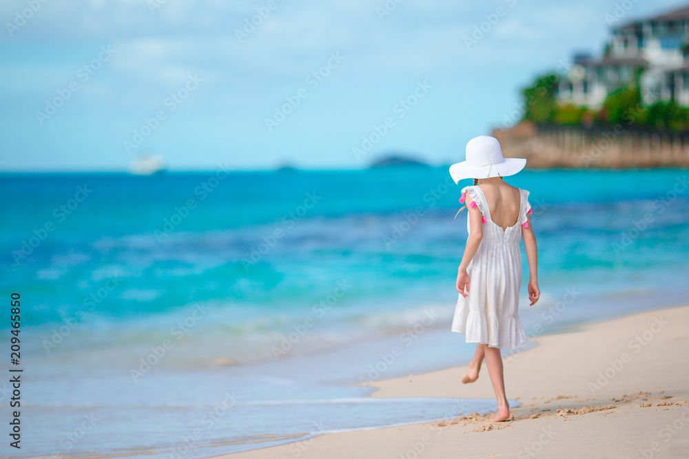Beautiful little girl in dress at beach having fun. Beautiful little girl in dress at beach having fun.