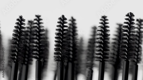 mascara brushes macro on white moving many brashes photo