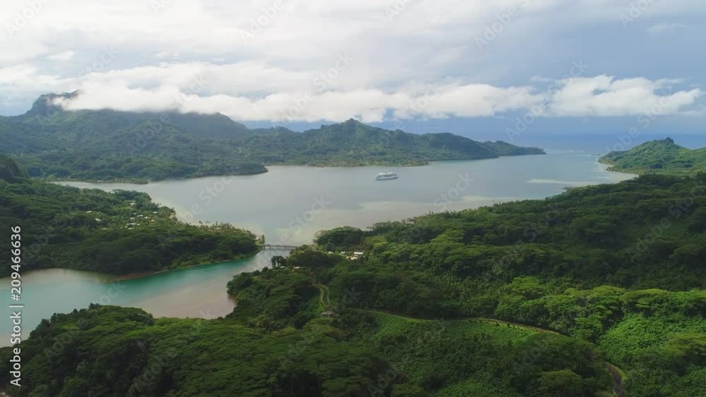 Aerial panoramic view of tropical paradise of Huahine island, Maroe Bay, slopes of hills covered in lush green rain forest - South Pacific Ocean, panorama landscape of French Polynesia from above Aerial panoramic view of tropical paradise of Huahine island, Maroe Bay, slopes of hills covered in lush green rain forest - South Pacific Ocean, panorama landscape of French Polynesia from above