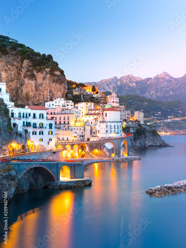 Night view of Amalfi cityscape on coast line of mediterranean sea, Italy