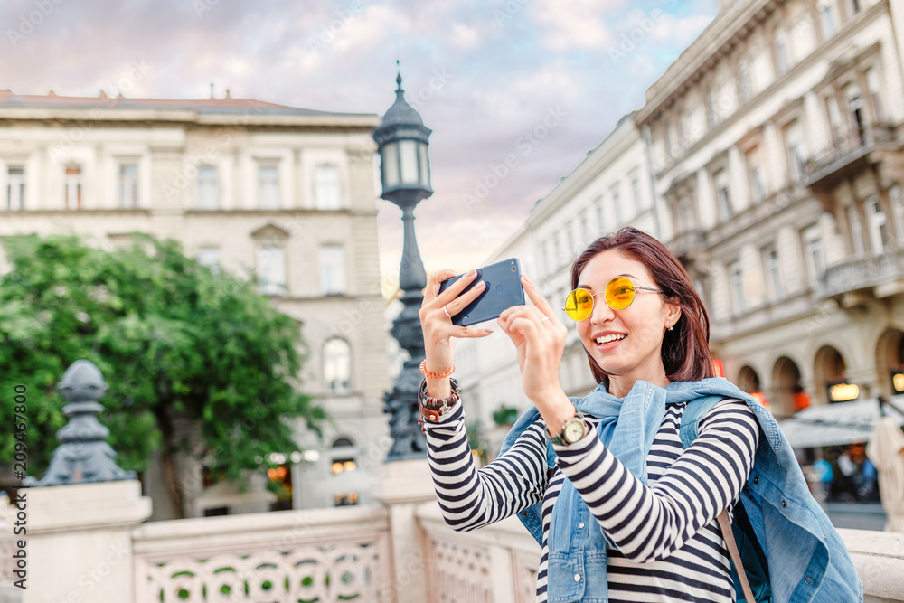 Tourist asian girl making photos on her smartphone, travel and vacation concept