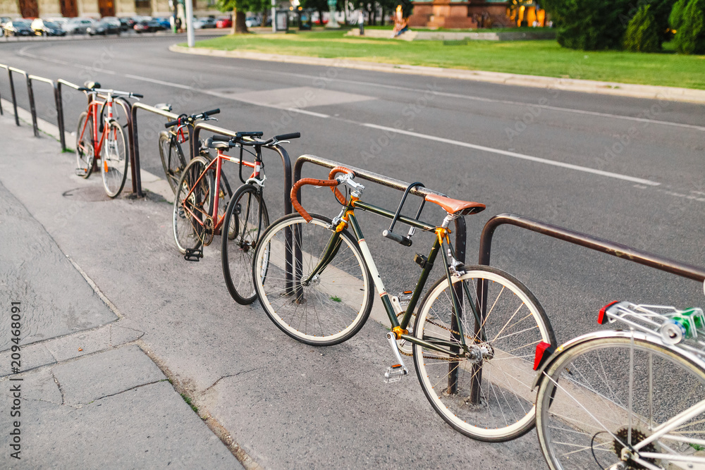 Parked Bicycles On Sidewalk near city Street.