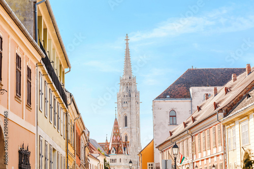 Narrow city street leads to one of the best known and most popular sights of Budapest Matthias Church