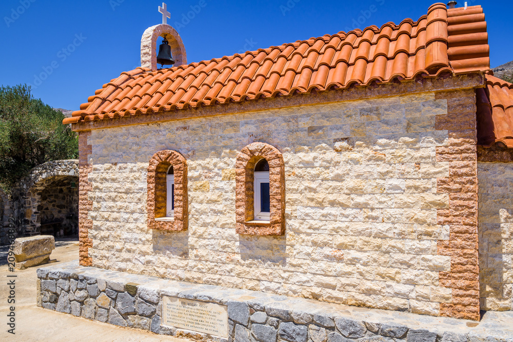 Church, Greece, Kos Island, Agios Theologos: old cozy little orange church with red roof chapel in traditional colors which perched on the greeksy sea next to a small tree over the barren mountains