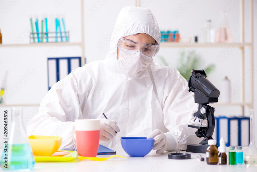Chemist checking and testing plastic dishes Chemist checking and testing plastic dishes
