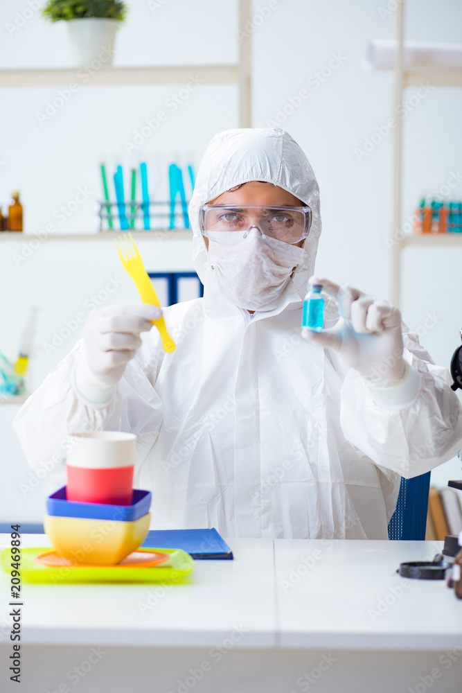 Chemist checking and testing plastic dishes