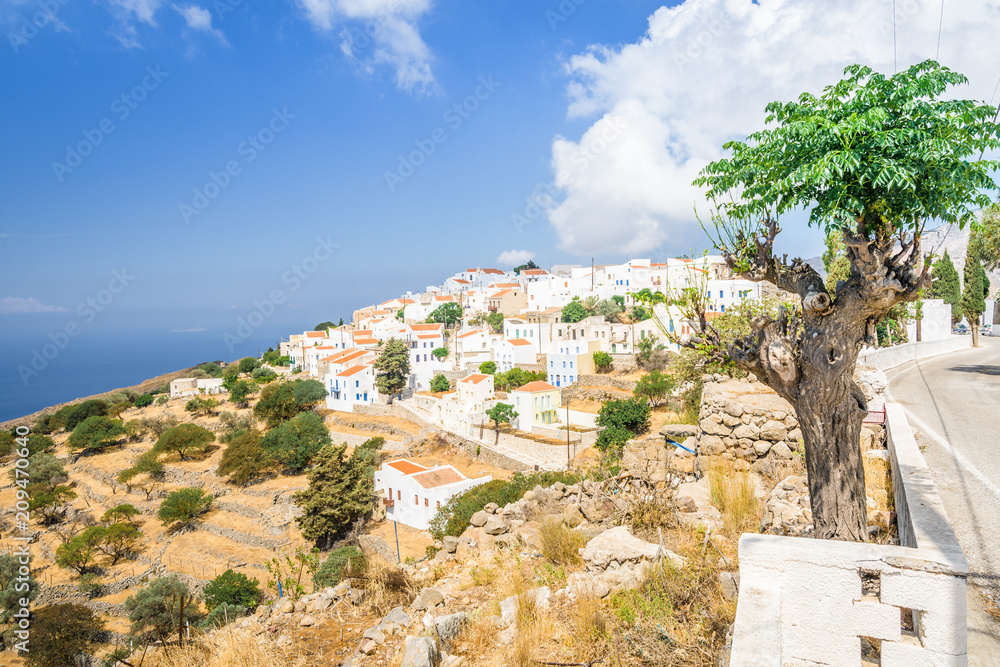 Nisyros Island, Nikia, Kos - Greece: Fantastic beautiful peaceful view of a small Greek mountain village with white houses and red roofs which has been spared from tourism at the edge of a volcano