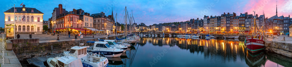 Panoramic view at dusk of the beautiful Honfleur harbour, which offers many fine restaurants overlooking the water