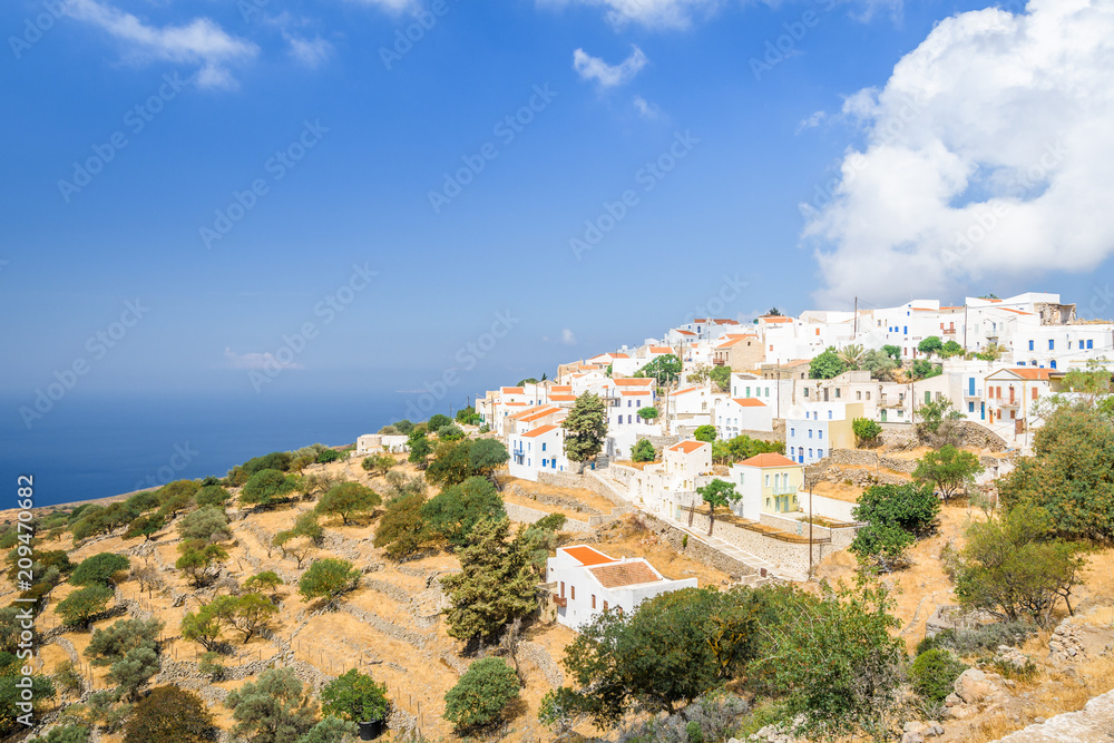 Nisyros Island, Nikia, Kos - Greece: Fantastic beautiful peaceful view of a small Greek mountain village with white houses and red roofs which has been spared from tourism at the edge of a volcano
