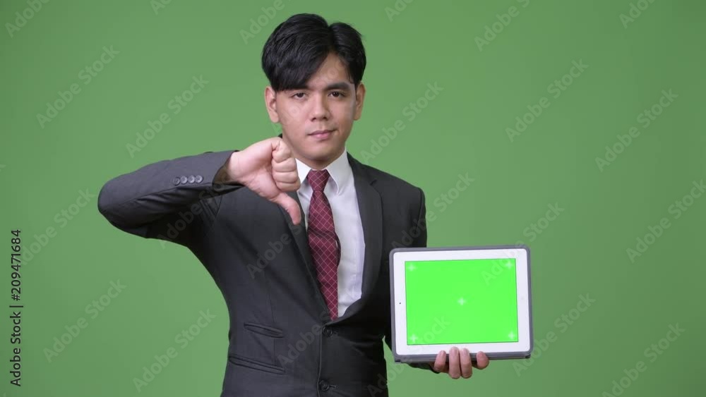 Young handsome Asian businessman using digital tablet Young handsome Asian businessman using digital tablet